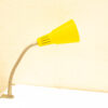 Bright yellow desk lamp with flexible neck, perfect for modern workspaces and reading areas.