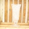 Elegant glass vase with geometric patterns against a rustic wooden background, perfect for home decor.