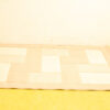 Elegant beige patchwork rug on a sunny yellow floor, enhancing any interior style.