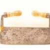 Rustic vintage meat cleaver with wooden handle, showcasing a weathered blade and historical charm.