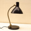Sleek vintage desk lamp with black cone shade and metallic arm, perfect for stylish interiors.