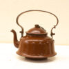 Vintage glossy brown kettle showcasing traditional craftsmanship and functionality.