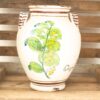 Handcrafted ceramic vase with floral design, rustic charm, and artisan details in wooden crate.