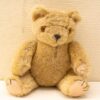 Charming vintage teddy bear with soft, warm brown fur and endearing amber eyes. Perfect gift!