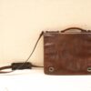 Vintage brown leather messenger bag with adjustable strap, perfect for style and everyday use.