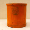 Charming vintage orange container with embossed label, showcasing unique character and nostalgia.
