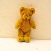 Charming vintage yellow teddy bear, perfect for nostalgia and cozy companionship.