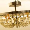 Elegant chandelier with crystals, adding timeless charm and warm ambiance to any interior space.
