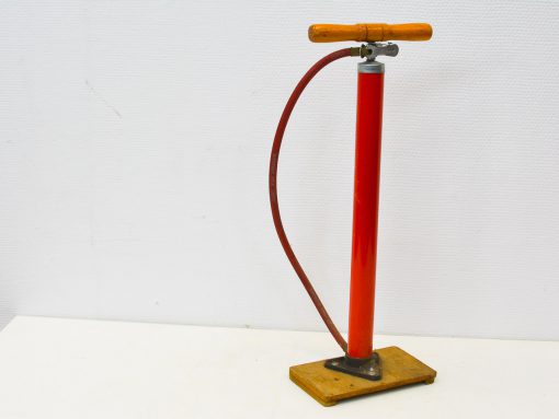 Vintage red bicycle pump with wooden handle, ideal for cycling enthusiasts and retro collectors.