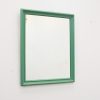 Vibrant green mirror with a sleek wooden frame, perfect for enhancing modern and retro interiors.