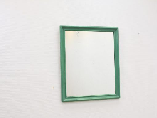 Vibrant green mirror adds fresh style and elegance to any living space.