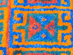 Vibrant handwoven tapestry featuring geometric patterns in rich colors for stylish home decor.