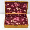 Charming wooden box with floral lining, ideal for jewelry storage and stylish home decor.