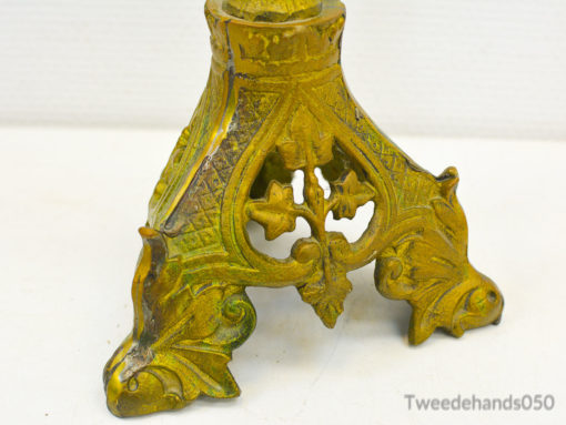 Elegant vintage metal stand with floral details and warm patina for stylish decor display.