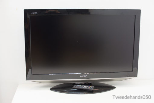Sleek Sharp TV and remote enhance modern living spaces with style and functionality.