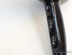 Sleek black hairdryer with ergonomic grip and intuitive controls for customizable styling and temperature.