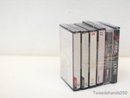 Vintage cassette tapes in clear cases, showcasing unique designs and nostalgic musical vibes.