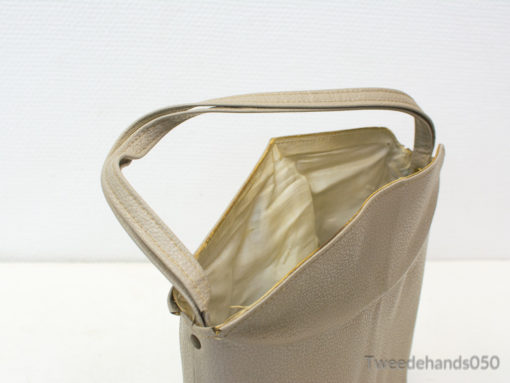 Chic beige handbag with modern texture, spacious interior, and comfortable handle for versatile style.