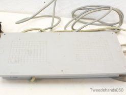 Vintage gray electronic device with beige cables, perfect for tech collectors and retro enthusiasts.