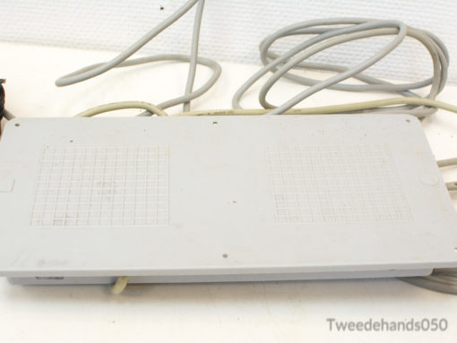 Vintage gray electronic device with beige cables, perfect for tech collectors and retro enthusiasts.