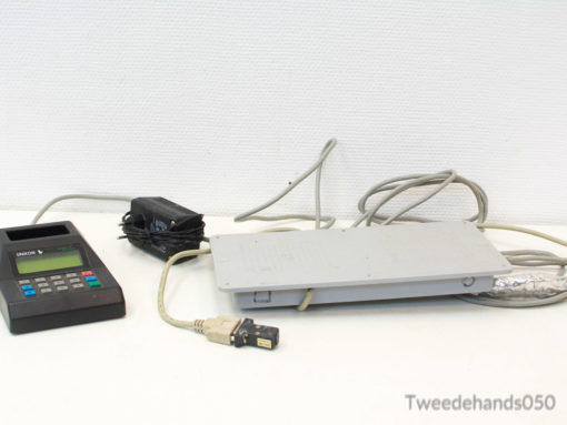Vintage handheld calculator and robust measurement device for industrial engineering applications.
