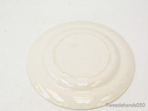 Elegant white ceramic plate with textured circular patterns, ideal for stylish dining and presentations.