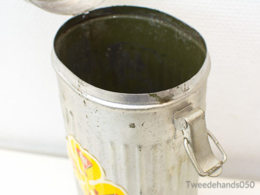 Charming vintage metal trash can with floral sticker, ideal for nostalgic home decor.