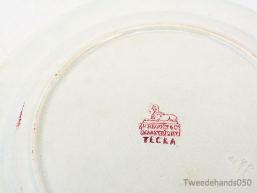 Antique Regout ceramic plate with lion emblem, elegant addition for collectors and decor.