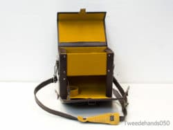 Stylish vintage brown bag with bright yellow interior; ideal for organized daily use.