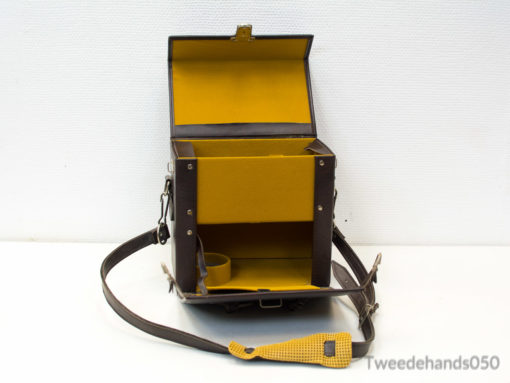 Stylish vintage brown bag with bright yellow interior; ideal for organized daily use.
