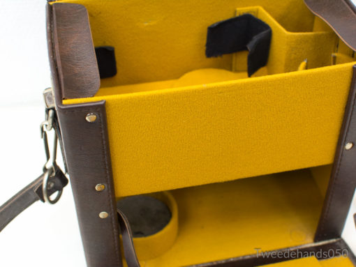 Vintage brown leather bag with yellow lining and organized compartments for stylish functionality.