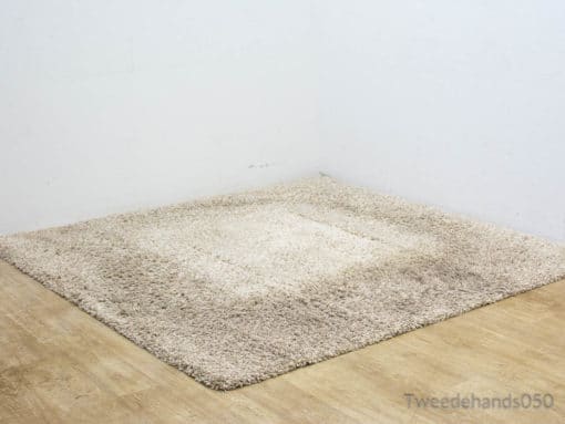 Elegant beige shag rug adds comfort and warmth to your homes cozy corner.