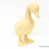 Whimsical yellow duck sculpture enhances modern decor with charm and elegance.
