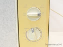 Vintage yellow microwave with user-friendly dials, perfect for adding retro charm to your kitchen.