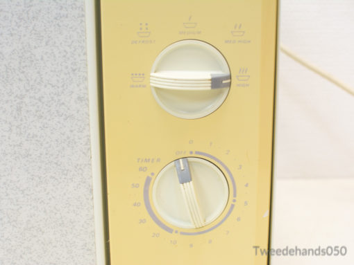 Vintage yellow microwave with user-friendly dials, perfect for adding retro charm to your kitchen.