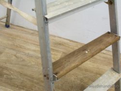 Sturdy vintage aluminum ladder with wooden steps, perfect for home improvement and DIY projects.