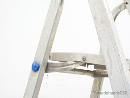 Sturdy used aluminum ladder with locking mechanism for safe DIY projects and repairs.