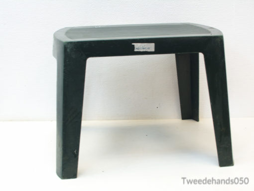 Durable black plastic stool with textured top, ideal for versatile indoor and outdoor use.