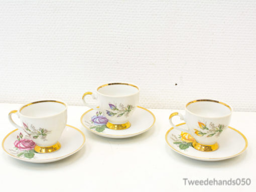 Vintage porcelain teacups with floral designs and gold trim, ideal for elegant tea gatherings.