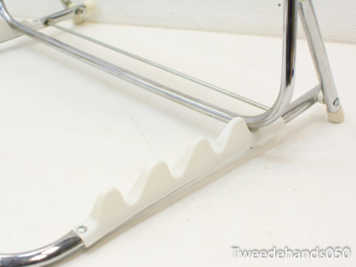 Sleek chrome stand with textured white base for organizing clothing and accessories stylishly.