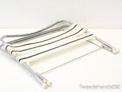 Sleek chrome folding chair with striped fabric, perfect for modern indoor and outdoor spaces.