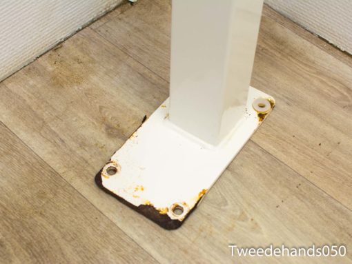 Aged white metal table leg with rustic rust details, ideal for vintage industrial decor.