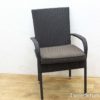 Stylish rattan dining chair with gray cushion, perfect for comfort in any elegant setting.