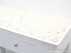 Elegant table with pebble top and drawer, ideal for modern coastal decor.