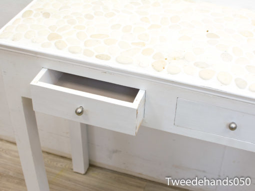 Stylish console table featuring a unique pebble top and practical storage drawers for modern decor.