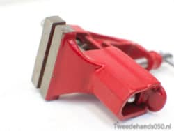 Durable red clamp for woodworking and crafts, ensuring a secure grip in DIY projects.