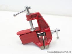 Sturdy red clamp for woodworking projects, adjustable with a strong grip for precision work.