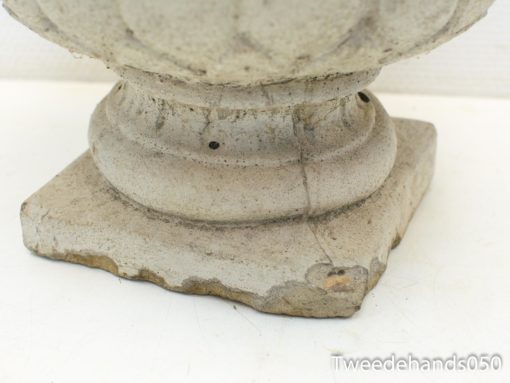 Rustic gray garden urn with elegant carvings, ideal for outdoor plant displays and decor.