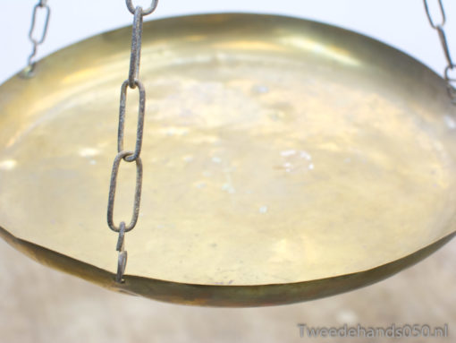 Vintage brass balance scale with decorative chains and charming patina, perfect for decor or function.