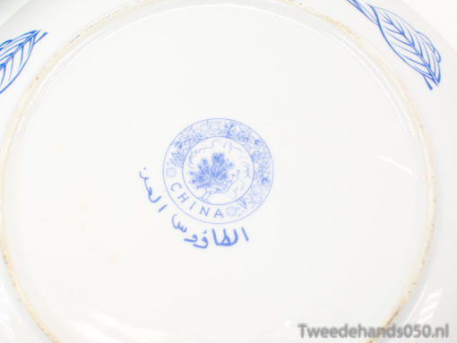 Antique porcelain plate featuring blue floral designs and cultural inscriptions, perfect for collectors.